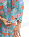 Close-up view of the decorative tie sleeve cuff on the embellished floral jalabiya