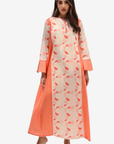 A woman modeling a long cream-colored kurta with a coral-orange leaf print and solid coral-orange striped side panels and cuffs, paired with clear high-heeled sandals against a light gray background.