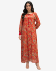 Luxury cotton chiffon dress with a flowing full-length silhouette, tie neckline, and elegant crimson floral print.