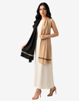 Camel side of Dual Tone Zigzag Cashmere Silk Shawl styled over a white dress with black zigzag border detail