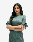 Close-up of the Emerald Paisley Ruffle Sleeve Linen Blend Dress highlighting the round neckline, paisley pattern, and ruffle sleeve details.