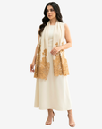A woman modeling a cream-colored sleeveless dress with a matching draped scarf featuring gold floral lace embroidery, set against a plain light gray background.