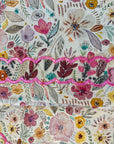 Premium Oriss cotton satin fabric displaying the ivory botanical floral print of the Ivory Botanical Oriss Cotton Satin Mukhawar for custom tailoring by Gharza Couture.