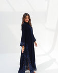 Full-length side view of navy velvet jalabiya showing the embroidered hem and side slit