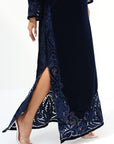 Lower hem detail of navy velvet jalabiya with hand embroidery and high side slit