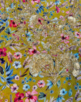 Premium crepe fabric displaying the mustard wildflower print of the Mustard Wildflower Crepe Mukhawar for custom tailoring by Gharza Couture.