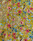 Close-up of the hand-embellished front on the Mustard Wildflower Crepe Mukhawar showcasing intricate crystal and bead detailing on premium crepe fabric.