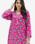 A woman modeling a bright pink long kurta dress with a white palm tree pattern, set against a plain light gray background.