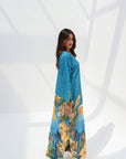 Full-length side view of turquoise jalabiya with tropical bird and botanical placement print