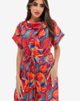Front view of the Prism Flow Sunset Abstract Linen Blend Jumpsuit with colourful abstract print, soft draped neckline and detachable waist tie.