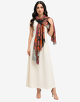 Royal Paisley Cashmere Silk Scarf wrapped around the neck with the printed ends draped over a white dress