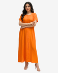 Close-up of the Sunset Glow Pleated Maxi Dress featuring delicate front pleats and a classic round neckline.