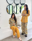 Women's two-piece travel wear outfit with elastic waist trousers and relaxed fit shirt.
