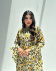 Close-up detail of citrus floral print linen blend fabric on luxury women's jalabiya