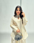 Close-up of the keyhole neckline detail on the Sahara Glow Travel Wear Set.