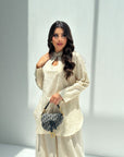 Sahara Glow Travel Wear Set featuring a longline top and wide-leg trousers in a soft neutral tone.