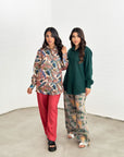 Women's tropical print travel wear set with wide-leg trousers and relaxed-fit shirt.