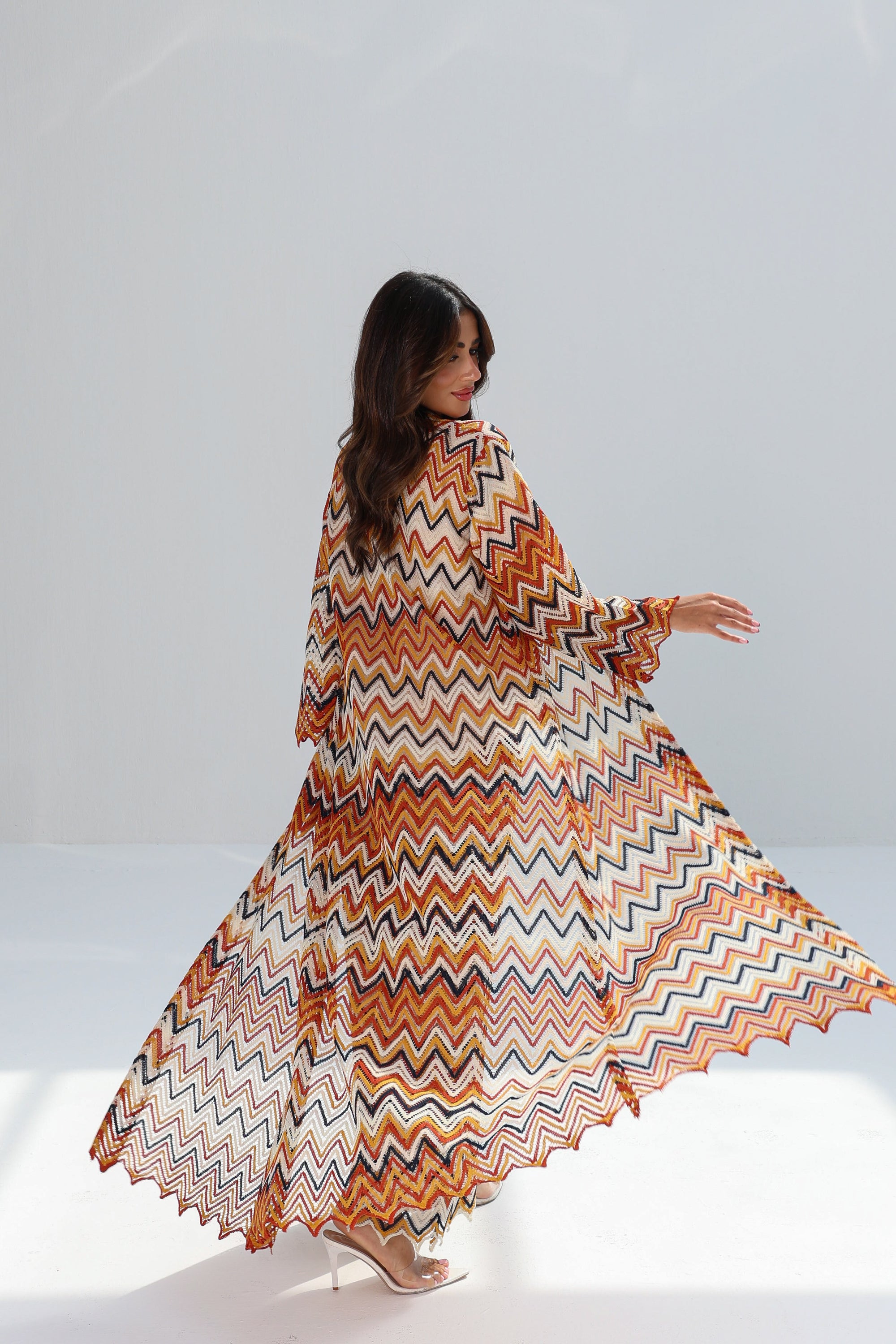 Back view of Amber Chevron long printed outer layer showing flowing silhouette