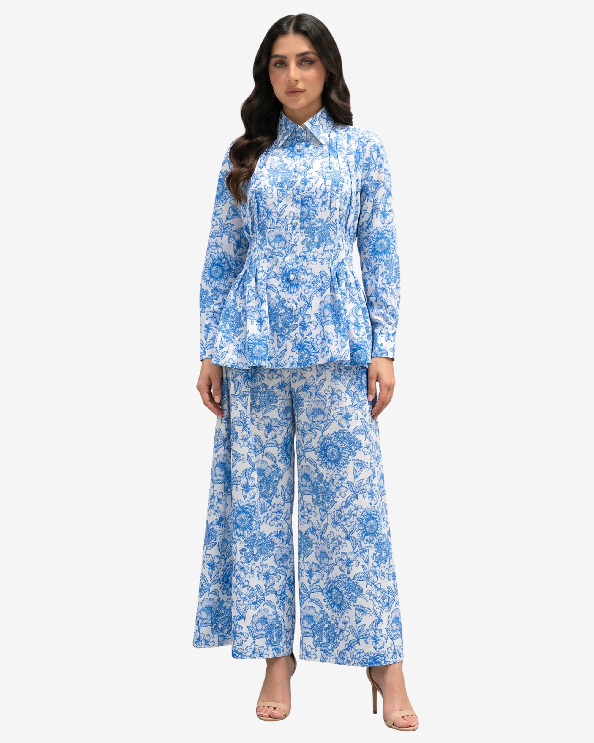 Model wearing Azure Blossom Pleated Linen Co-ord Set featuring a blue floral linen top with pleated detailing, back waist belt and lined wide-leg trousers by Gharza Couture.
