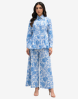 Model wearing Azure Blossom Pleated Linen Co-ord Set featuring a blue floral linen top with pleated detailing, back waist belt and lined wide-leg trousers by Gharza Couture.