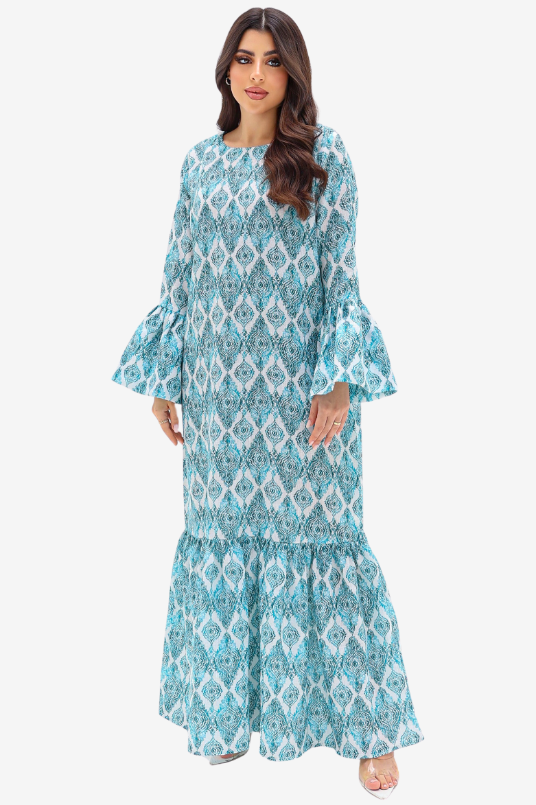 A woman modeling a long-sleeved maxi dress with a blue and white geometric pattern, flared bell sleeves, and a tiered ruffled hem against a light gray background.