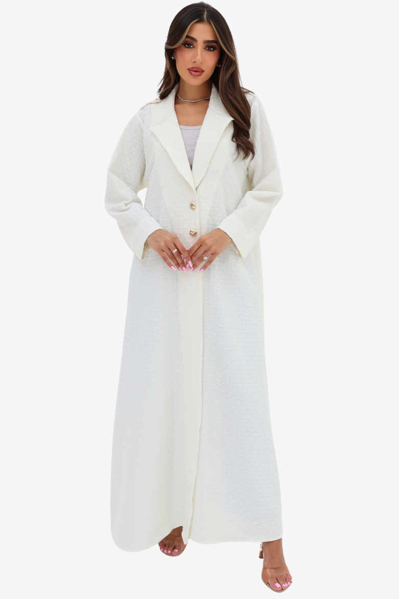 Front view of the Ivory White Blazer Textured Stretch Abaya by Gharza Couture with lapel collar and gold-tone buttons.