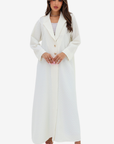 Front view of the Ivory White Blazer Textured Stretch Abaya by Gharza Couture with lapel collar and gold-tone buttons.