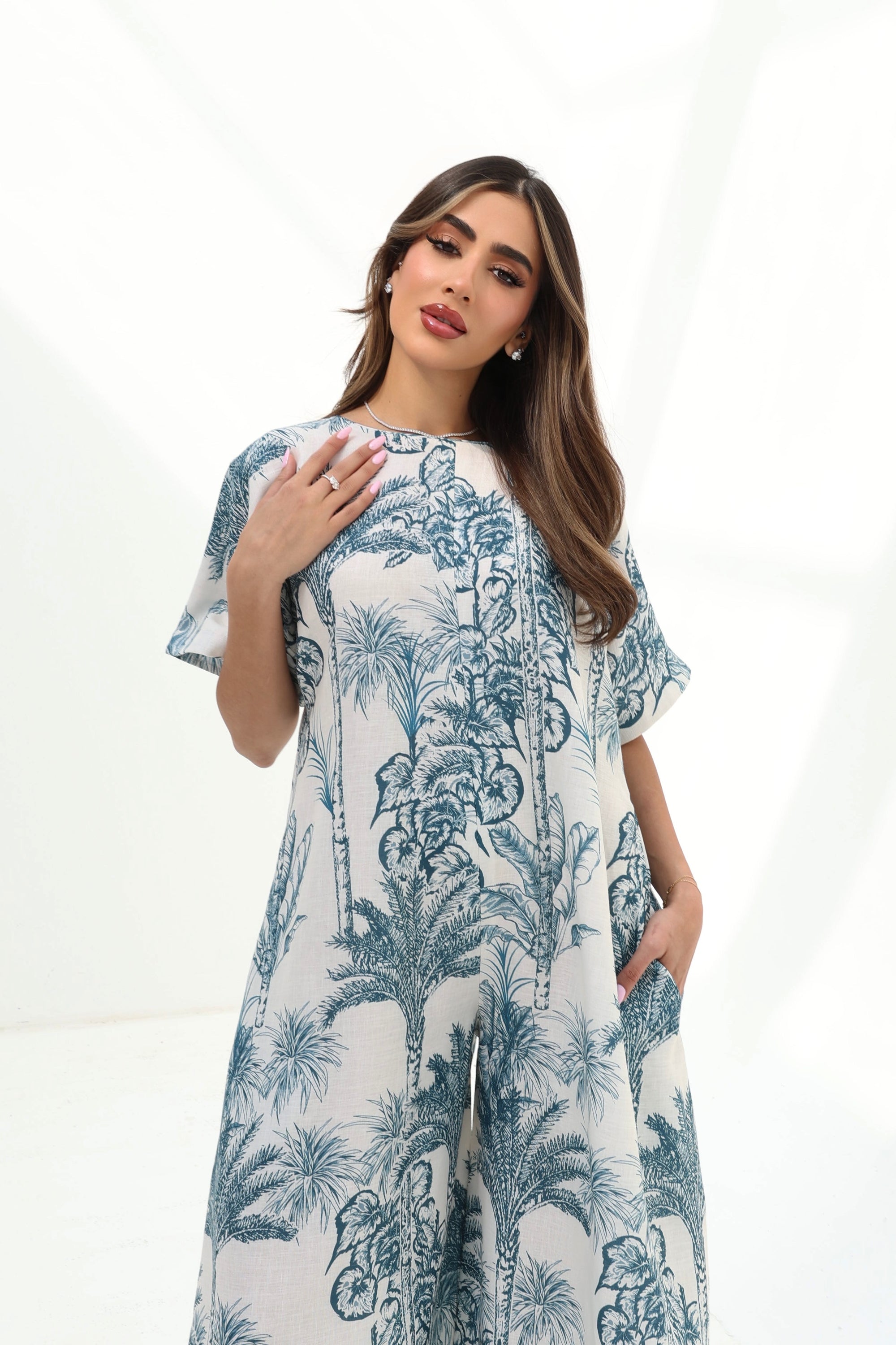 Portrait of the Blue Tropique Linen Blend Jumpsuit by Gharza Couture featuring elegant tropical artwork, relaxed silhouette and premium linen blend fabric.