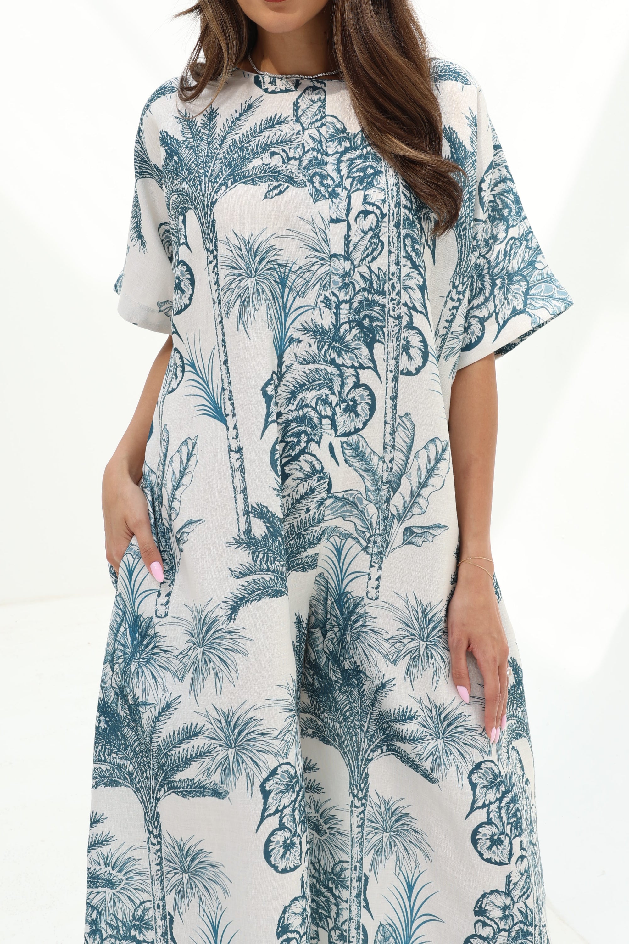 Close-up of the Blue Tropique Linen Blend Jumpsuit showcasing the blue botanical print, round neckline and lightweight linen blend fabric.