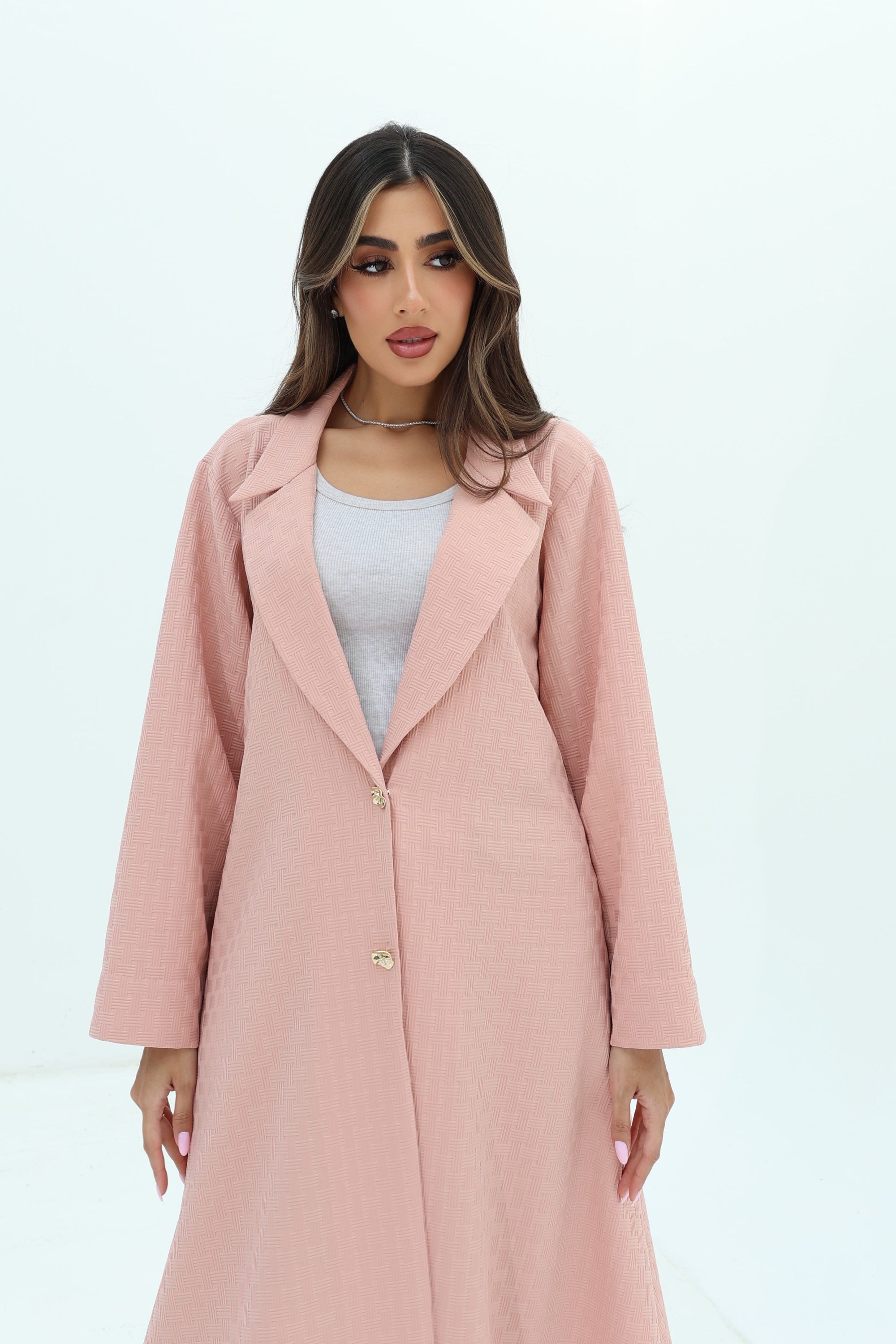 Close-up of the Blush Pink Blazer Textured Stretch Abaya by Gharza Couture highlighting the textured fabric and refined tailoring.