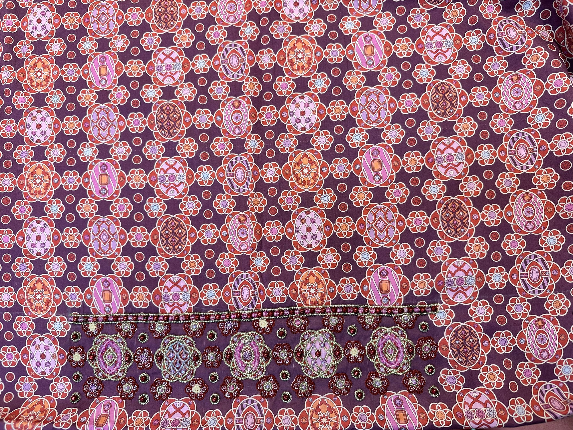 Premium printed cotton fabric displaying the burgundy medallion pattern of the Burgundy Medallion Cotton Mukhawar for custom tailoring by Gharza Couture.