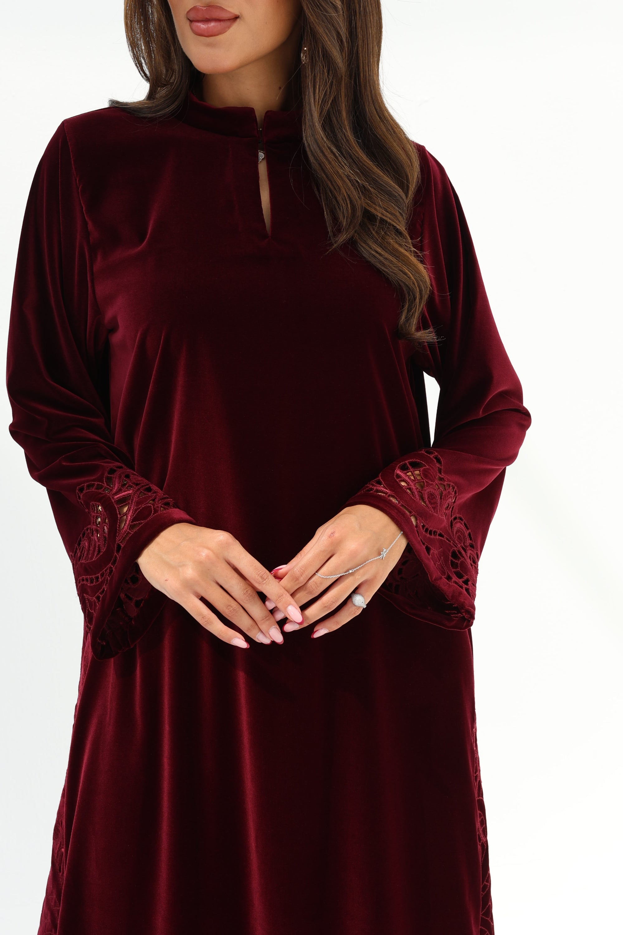 Front detail of Burgundy Velvet Jalabiya featuring a round neckline and flowing long sleeves