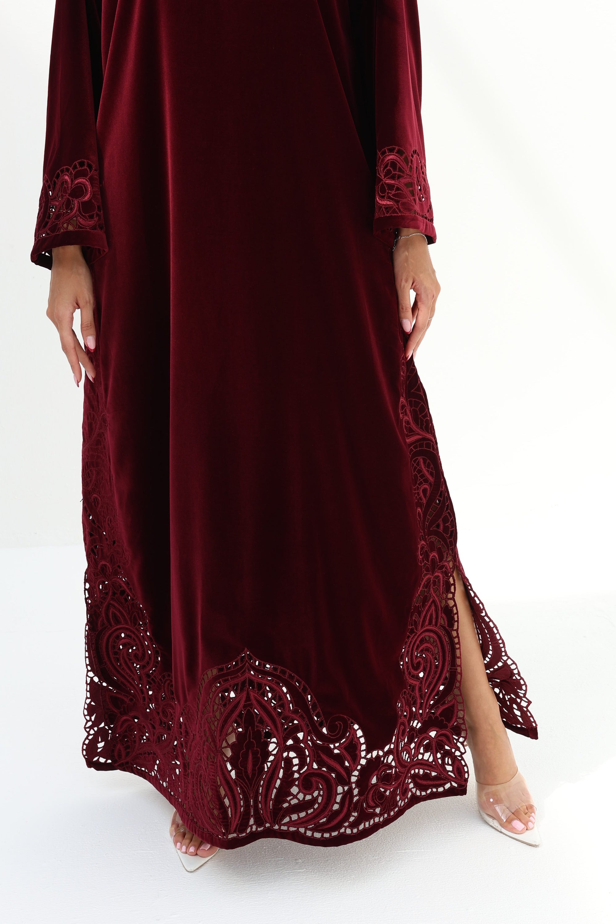  Lower hem detail of burgundy velvet jalabiya with intricate tonal embroidery