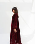 Full-length side view of burgundy velvet jalabiya with embroidered border