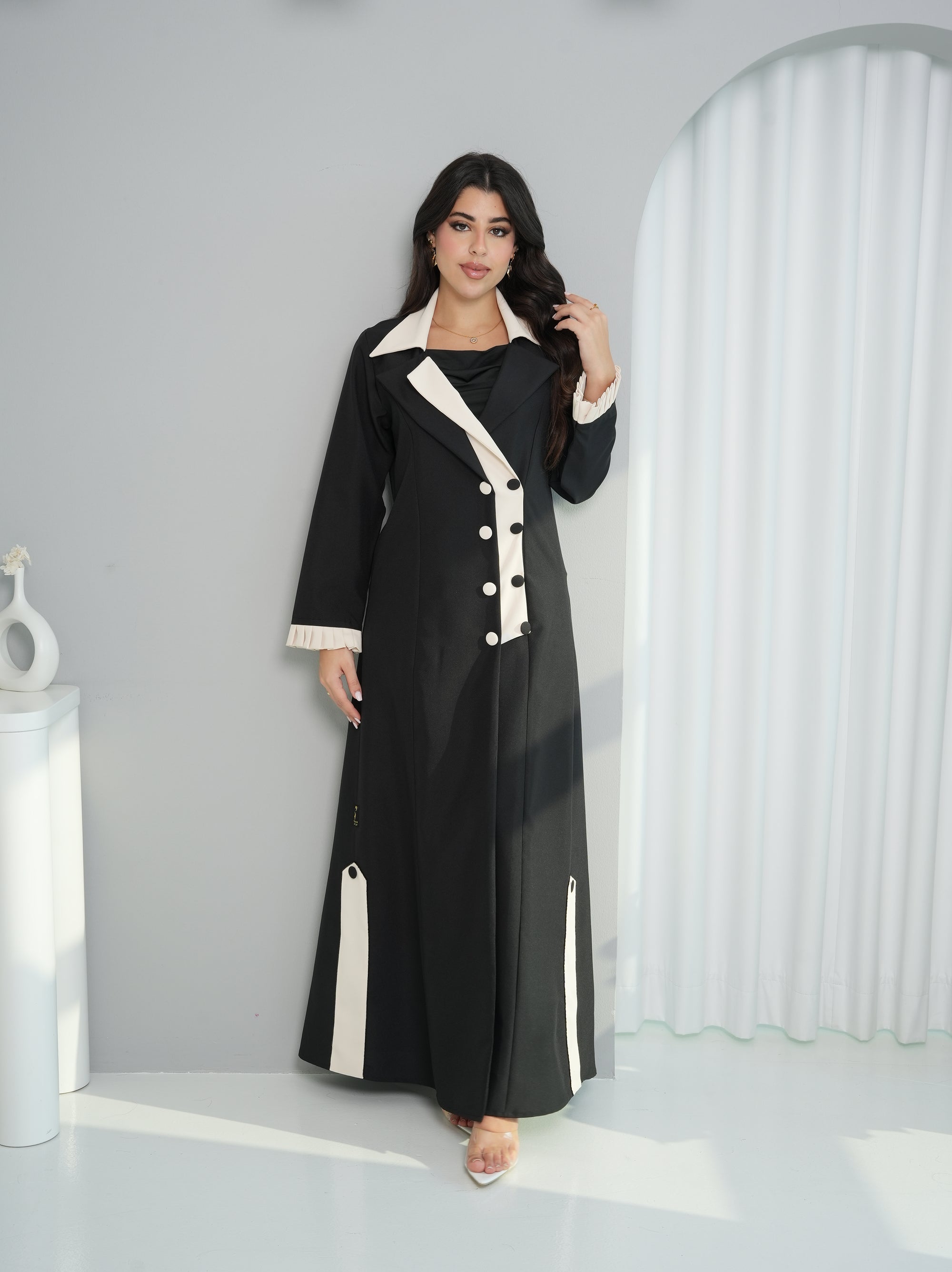 Lifestyle view of Contrast Lapel Abaya in premium black abaya fabric with ivory contrast details by Gharza Couture