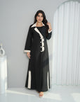 Lifestyle view of Contrast Lapel Abaya in premium black abaya fabric with ivory contrast details by Gharza Couture