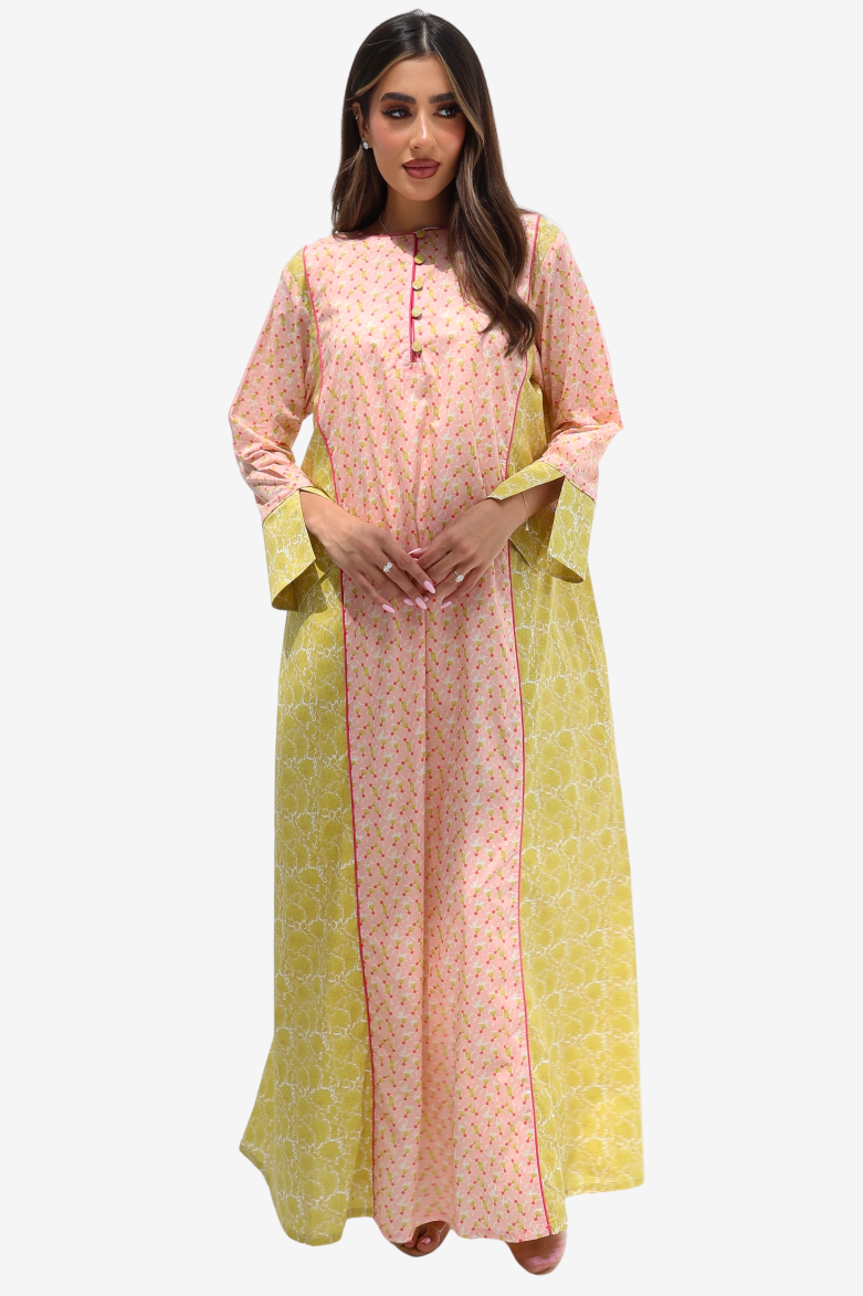 A woman modeling a peach-pink and yellow printed traditional outfit with a matching yellow dupatta against a light gray background.