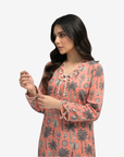 Close-up of the rope trim neckline, front bow and sleeve detail on the Coral Oasis linen blend jalabiya