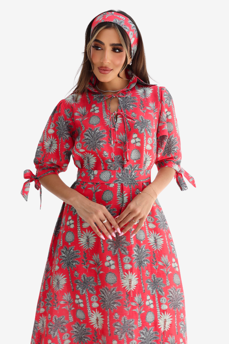 Woman wearing Coral Oasis Hand Embellished Linen Blend Dress in tropical palm print