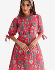 Woman wearing Coral Oasis Hand Embellished Linen Blend Dress in tropical palm print
