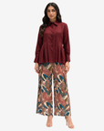 Crimson Elegance Pleated Linen Co-ord Set featuring a pleated long-sleeve linen top and botanical print lined wide-leg trousers with an elastic waistband by Gharza Couture.