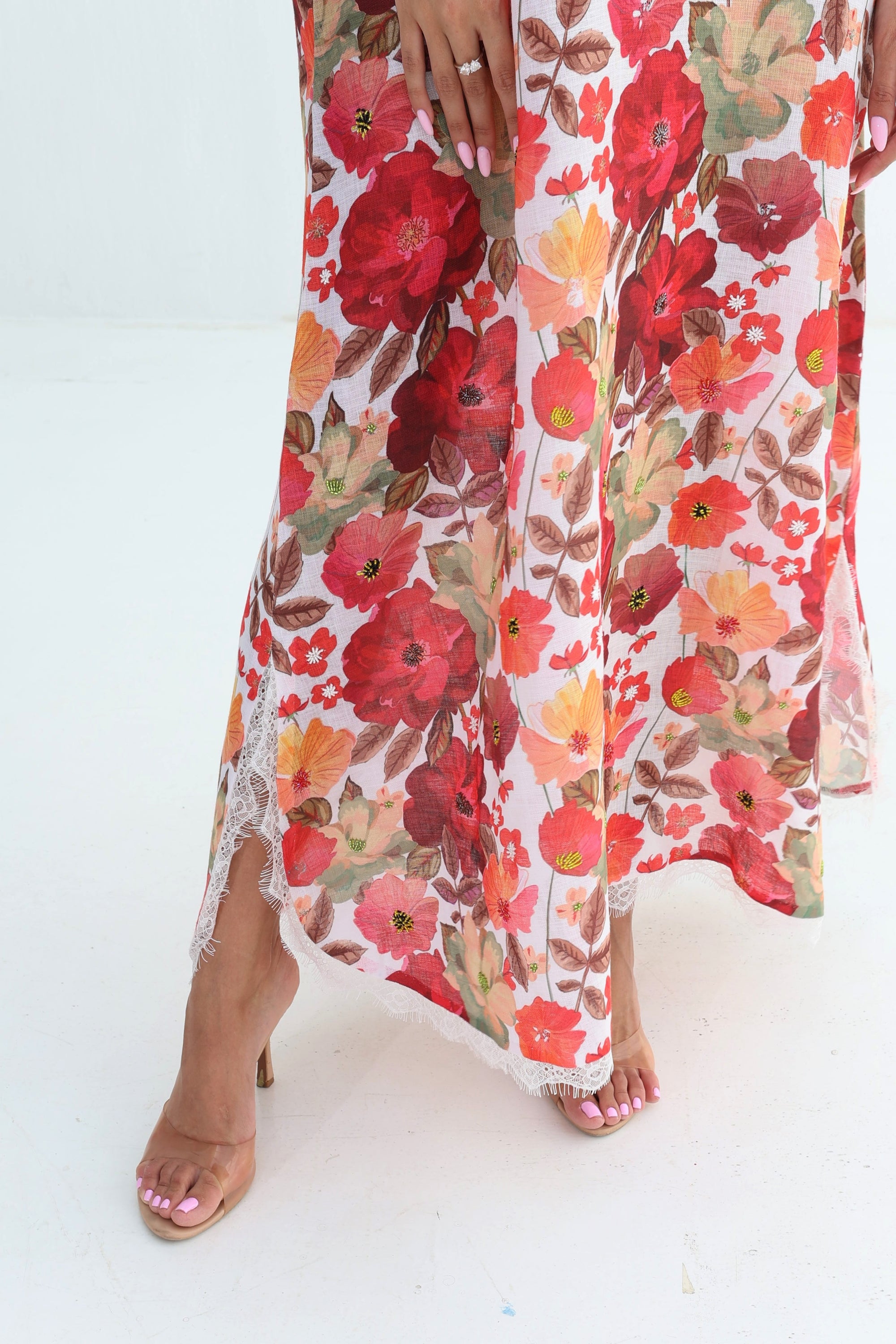 Crimson Bloom Jalabiya hem detail showing vibrant floral print and lace trim