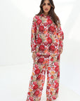 Full-length view of the Crimson Bloom Linen Blend Co-Ord Set with button-down shirt, elastic waist trousers and floral print by Gharza Couture.