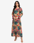 Luxury Emerald Botanica linen blend jalabiya with colorful floral botanical print, lace-up neckline and elegant modest design by Gharza Couture.