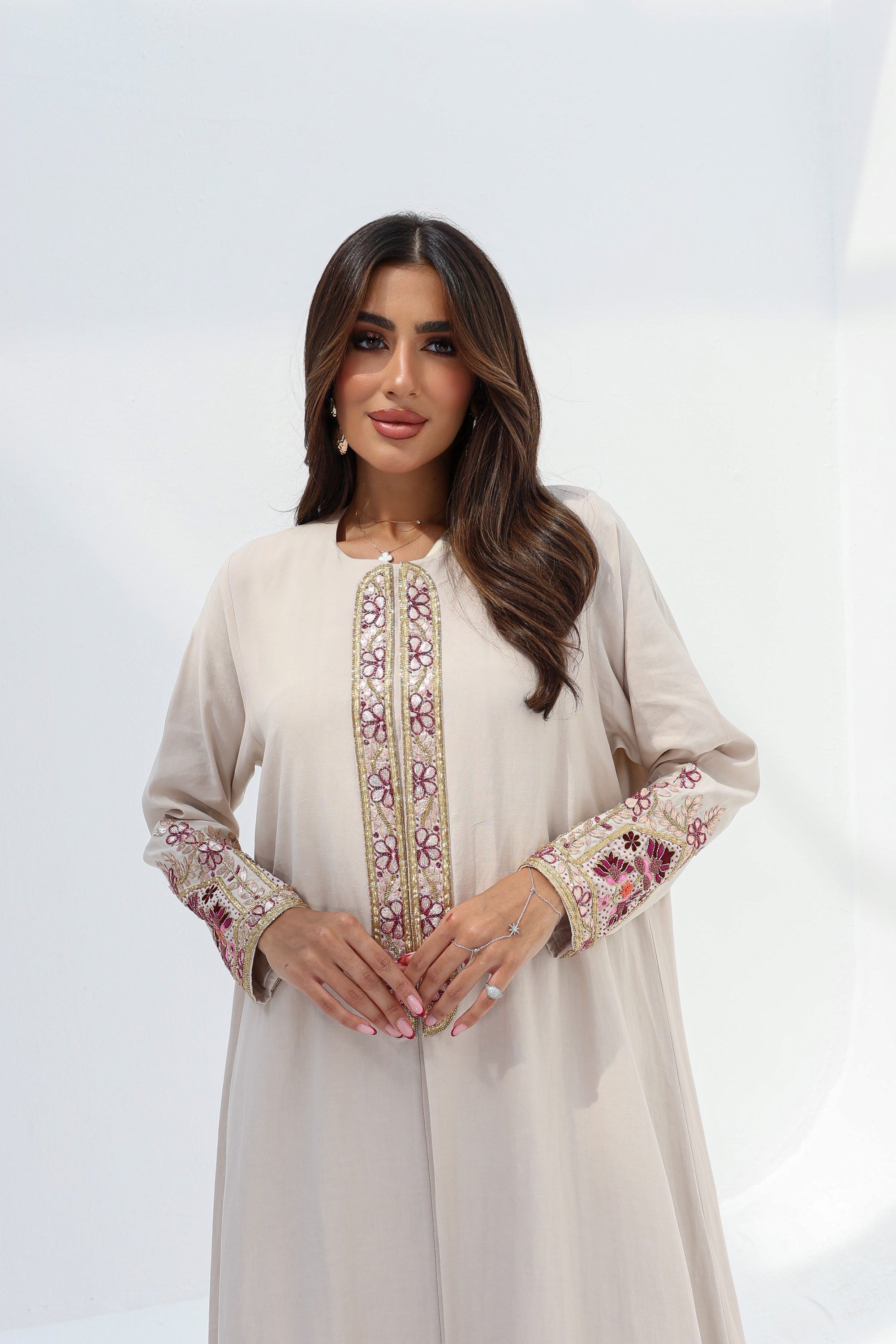 Front view of ivory Floral Embroidered Trim Abaya with flowing modest silhouette