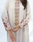 Ivory embroidered abaya showing floral trim along the front and sleeve cuffs
