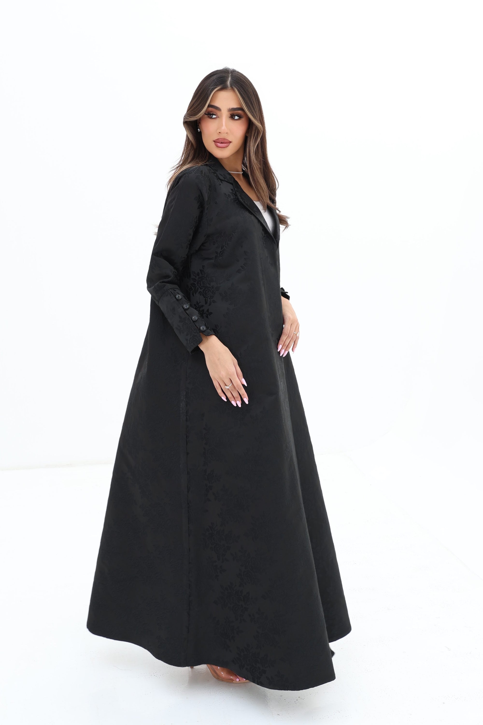 Side view of the Floral Textured Blazer Abaya by Gharza Couture highlighting its graceful drape and elegant open-front design.
