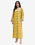 Side view of the Golden Meadow Hand Embellished Cotton Jalabiya highlighting handcrafted embellishment, botanical floral pattern and graceful modest fit.