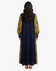 Back view of the Golden Meadow Tie Neck Cotton Chiffon Dress showcasing the flowing chiffon overlay and contrasting cotton back panel.