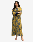 Luxury cotton chiffon dress with a flowing full-length silhouette, tie neckline, and elegant golden floral print.